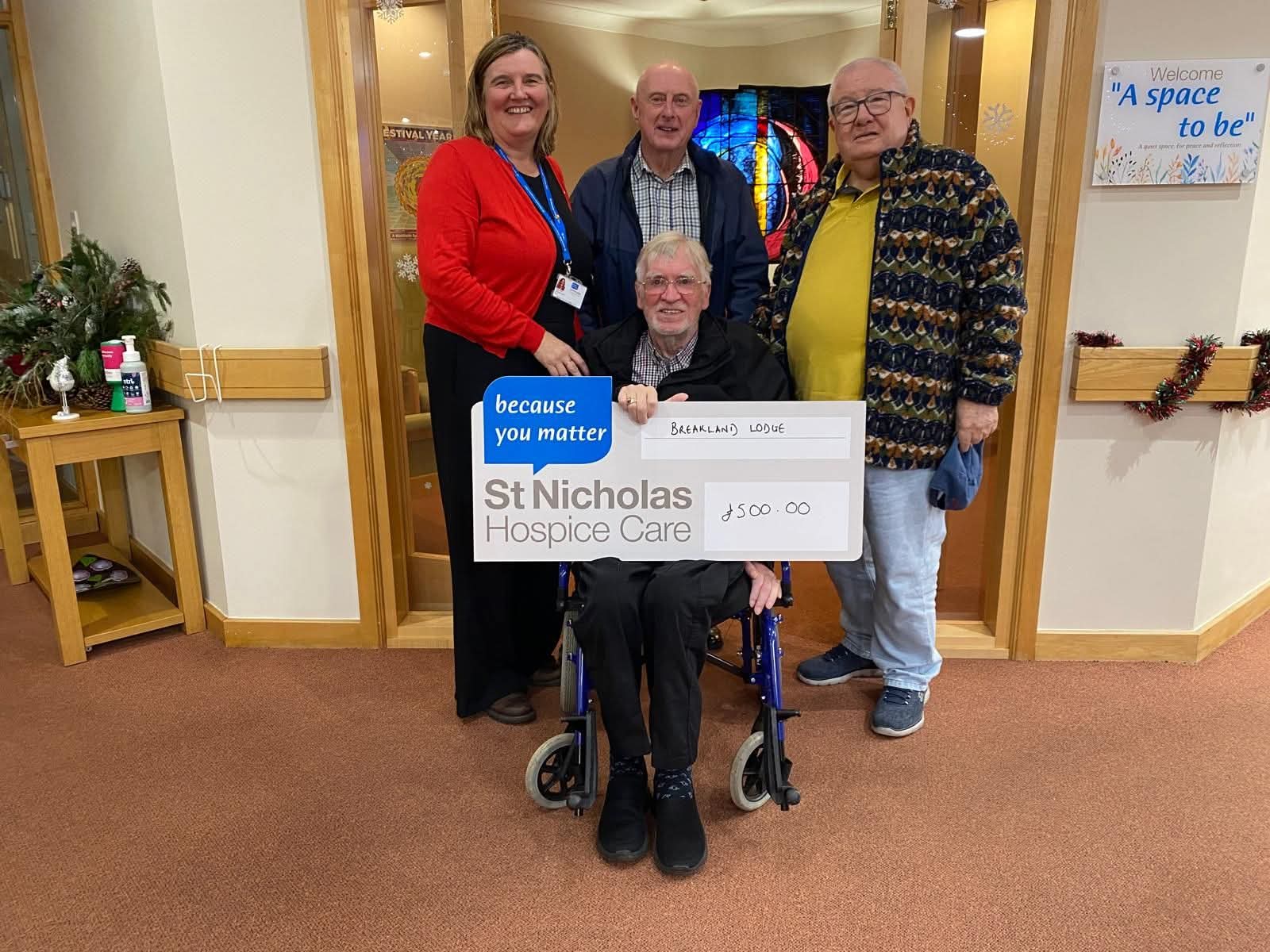 Five people at Breakland Lodge presenting a £500 cheque to St Nicholas Hospice Care